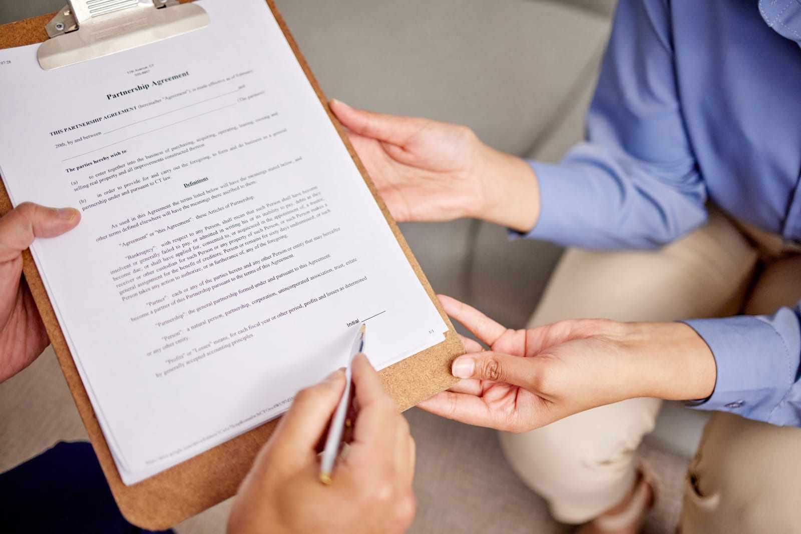Legal Implications of Mergers, Acquisitions, or Divestitures Image of hands holding a contract or document for a property or house agreement and sale, symbolizing legal transactions, featuring the 411 Corporate Law logo and highlighting 'Legal Implications of Mergers, Acquisitions, or Divestitures,' aligning with the page's focus on legal aspects of corporate transitions.