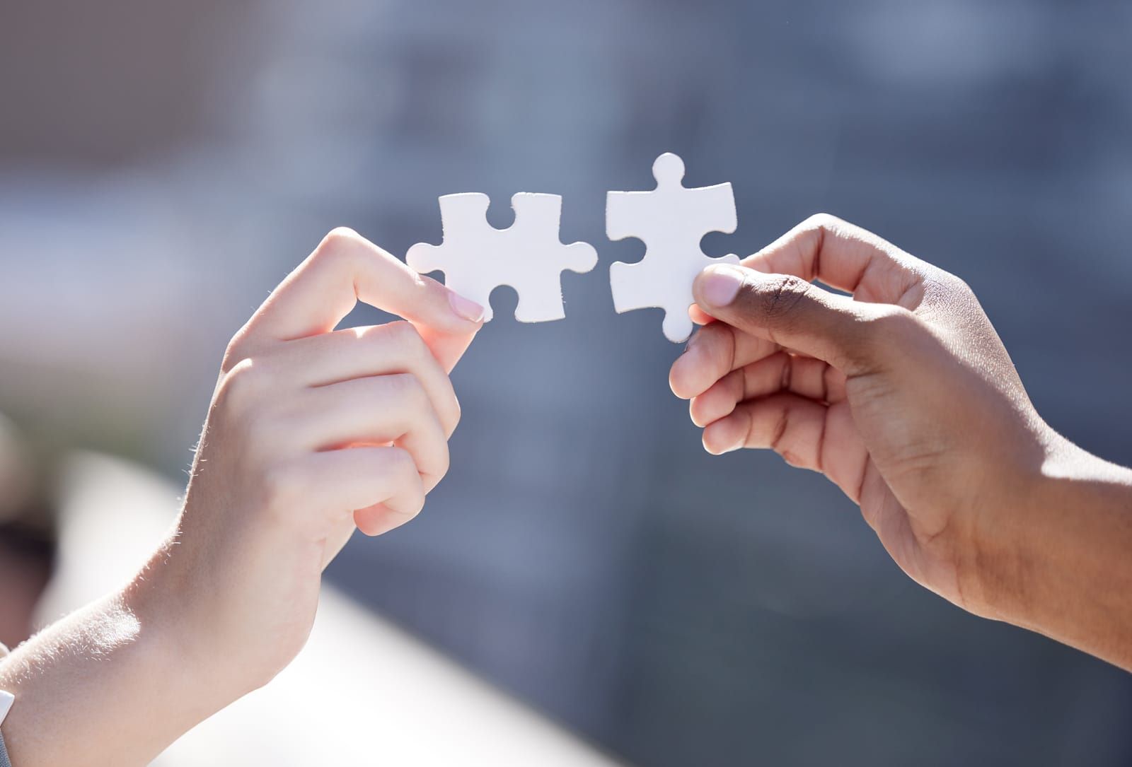 Termination Due to Merger or Acquisition Image of hands of business people connecting puzzle pieces, symbolizing teamwork and collaboration, featuring the 411 Corporate Law logo and highlighting 'Termination Due to Merger or Acquisition,' aligning with the page's focus on corporate transitions.