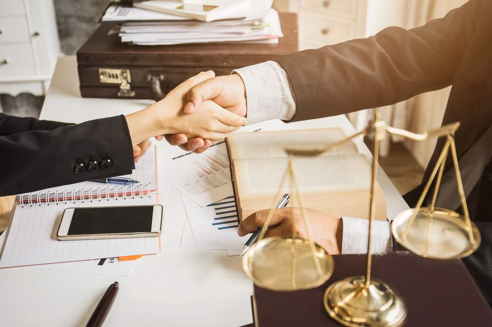 Image of an Asian lawyer working diligently in a lawyer's office, featuring 411 Corporate Law and highlighting 'Why Hire a Corporate Tax Lawyer?', ensuring it aligns with the page's context on legal tax expertise for businesses.